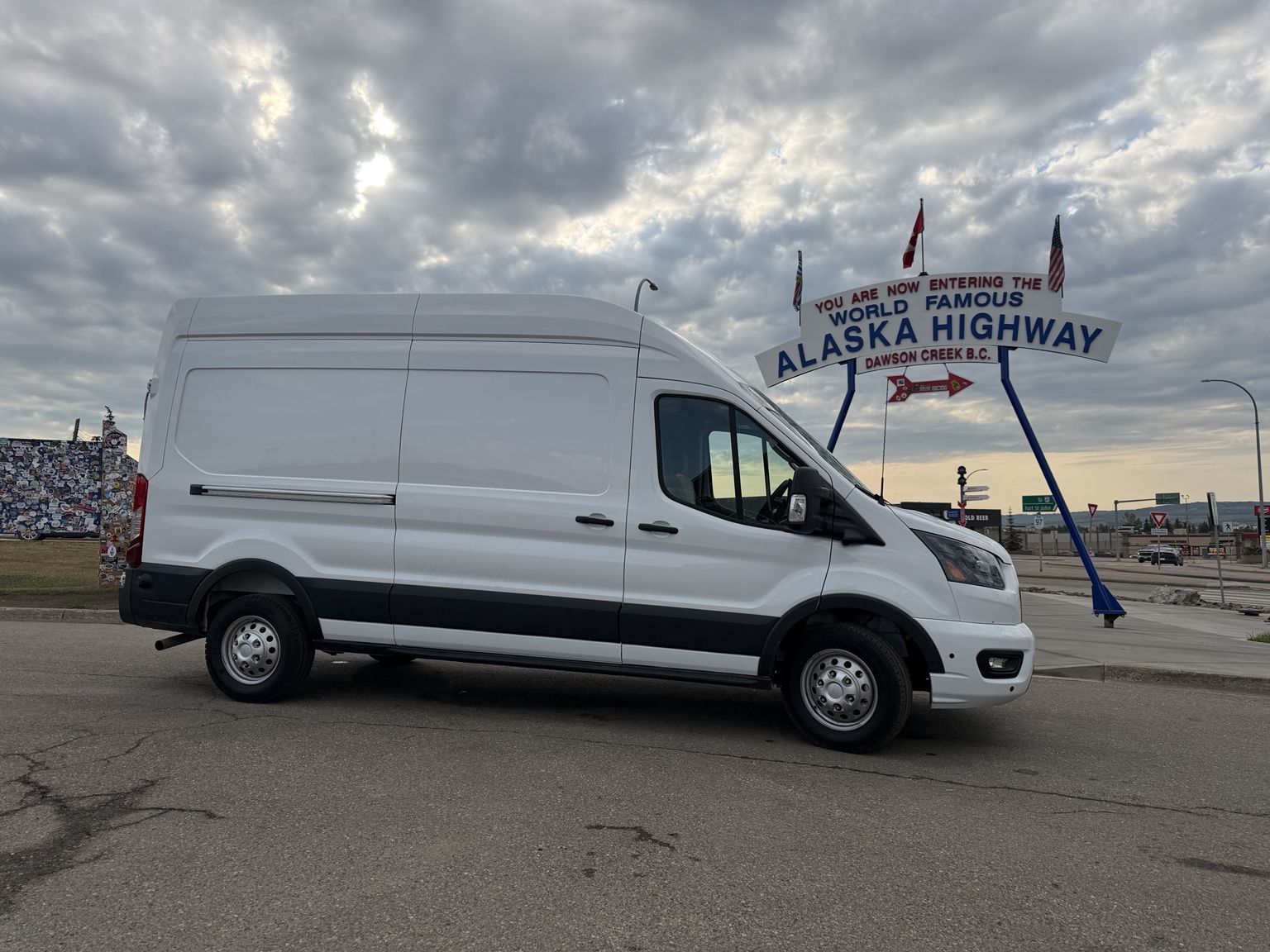 Ty and Julie’s white Ford Transit at Mile Zero of the Alaska Highway in Dawson Creek